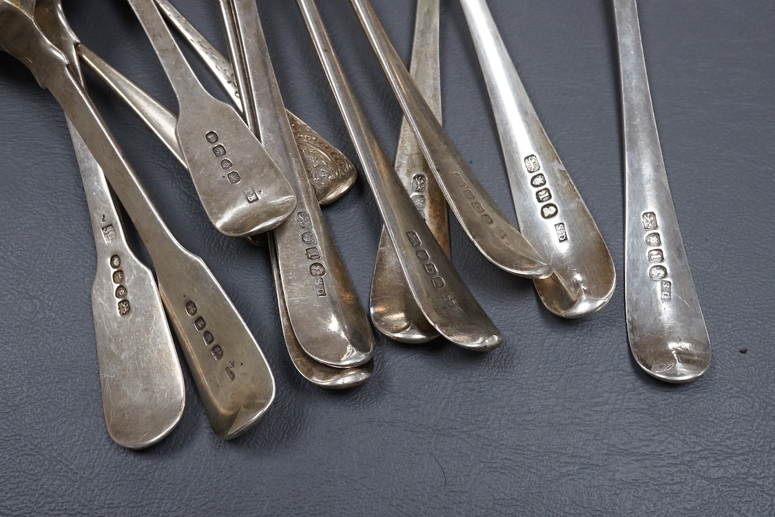 Seven assorted George III bright cut engraved silver Old English pattern table spoons, together with five other silver spoons, various dates and makers, 19.4oz.